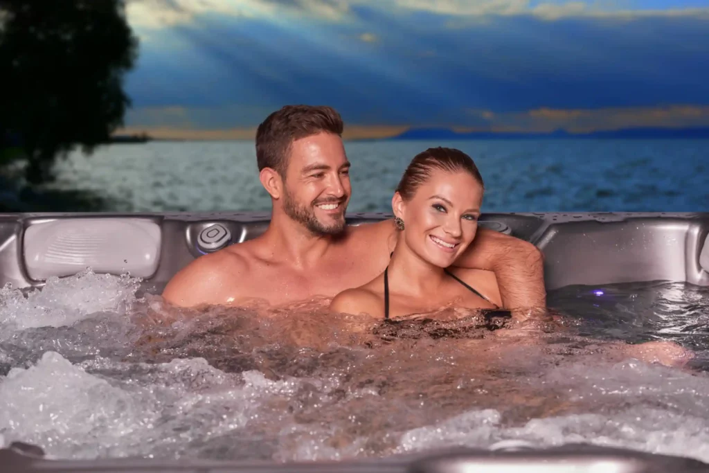 Picture of a happy couple in their Wellis hot tub after reading the hot tub buying guide.