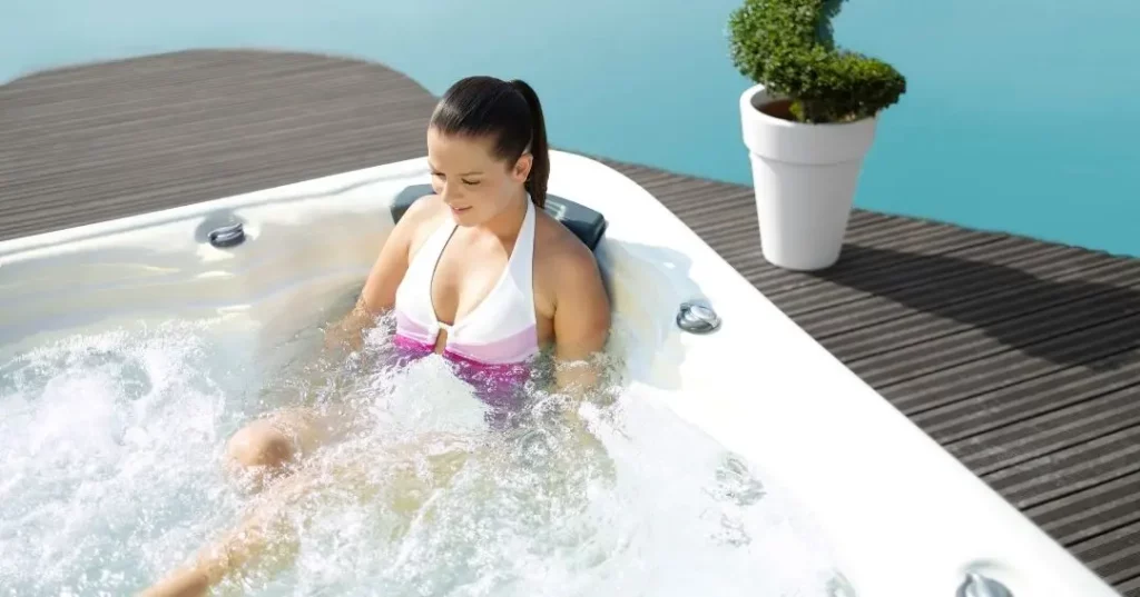 Person soaking in a hot tub after reading, "Do Hot Tubs Help Sore Muscles?"